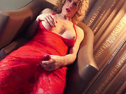 Busty mature TS Delia DeLions cums through her dress